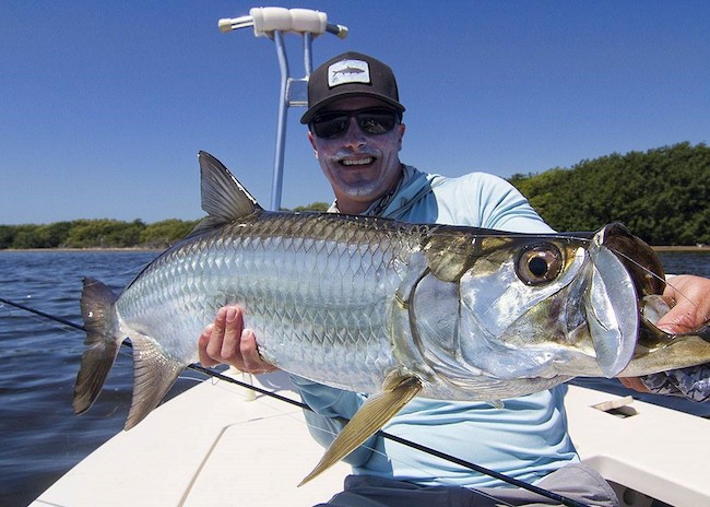 Sam showing the fish he captured on the fly fishing tour.