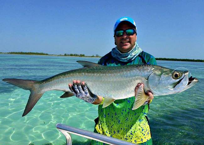Charles showing his catch during a fly fishing tour.