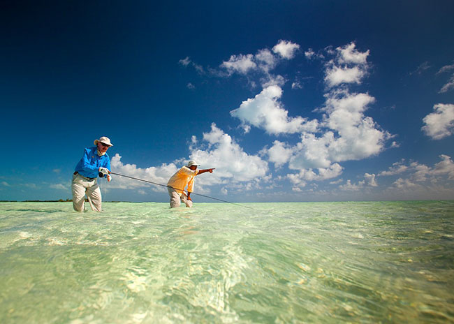 The fly fishing instructor pointing out Andrew where to fish next.